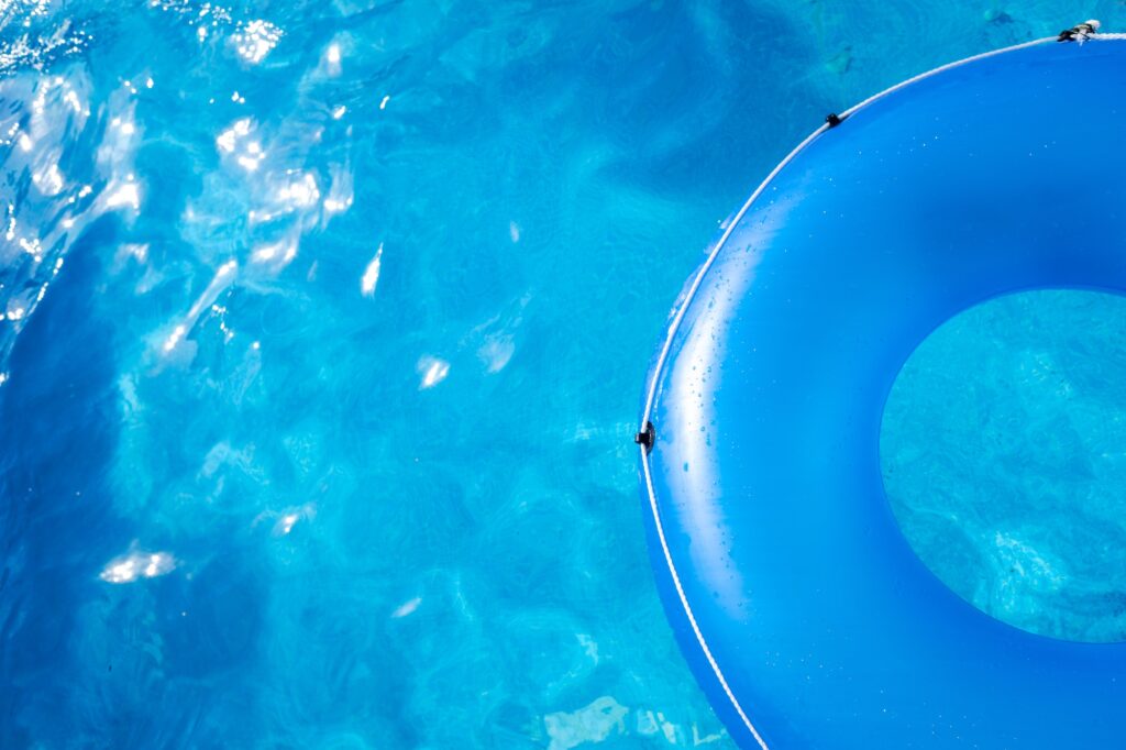 A large blue round float on a pool of transparent water, copy space.