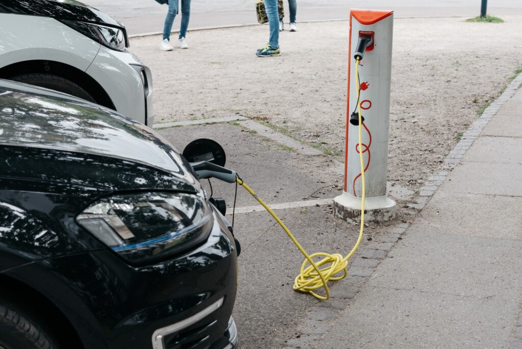 Charging an electric car with the power cable supply plugged in charging station