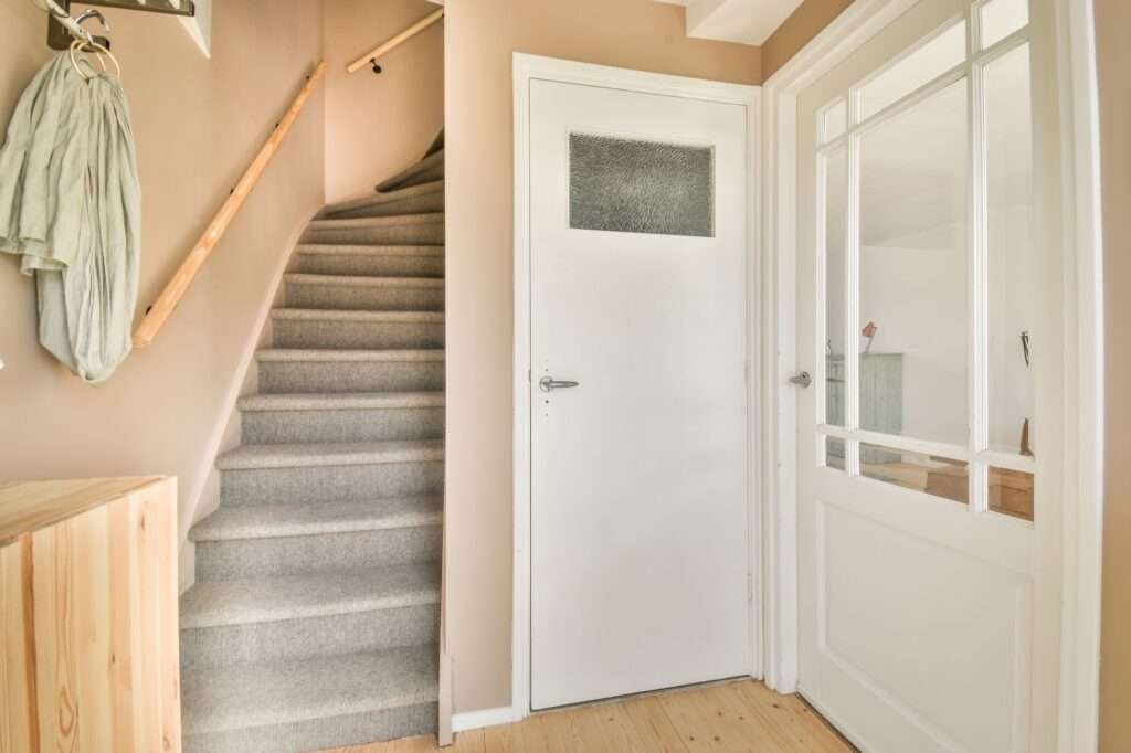 Light narrow hallway with staircase