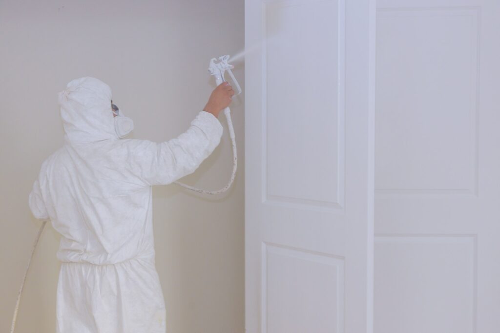 Master painting wood doors with spray gun processing painting base door house