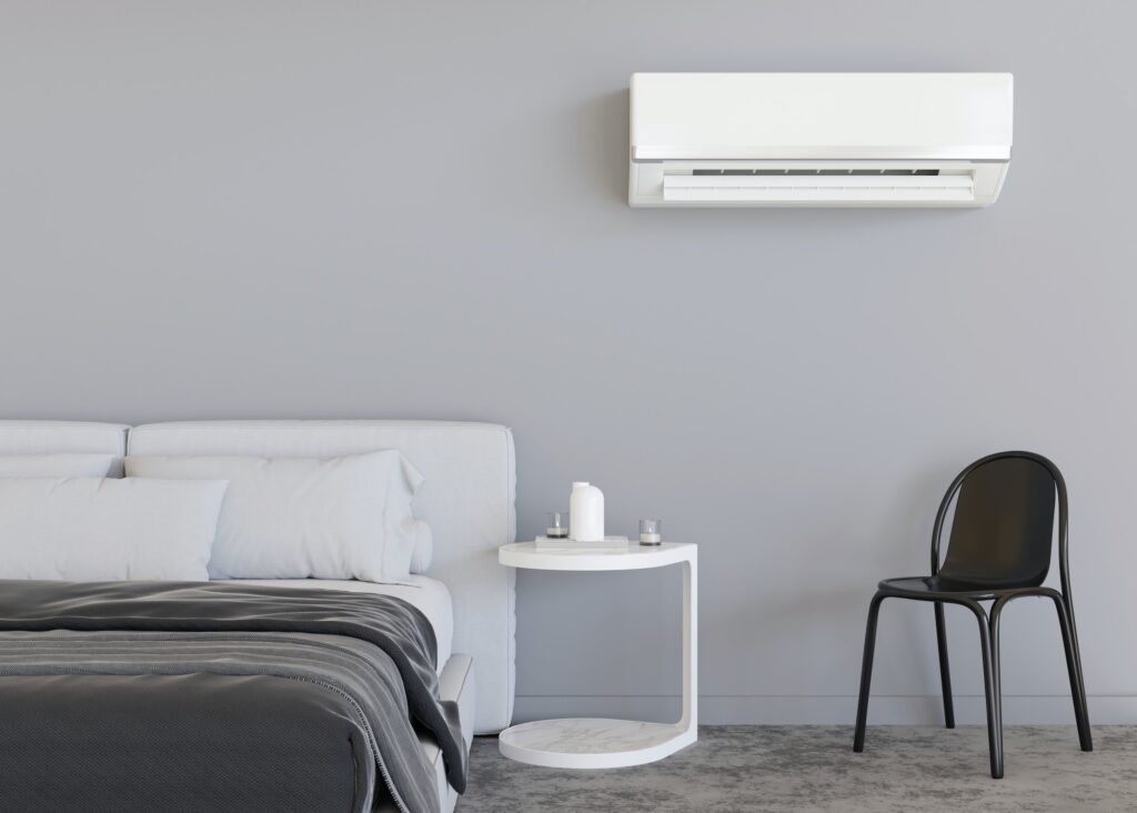 Modern air conditioner hanging on the wall in room. Cooling product for hot climate in summer.