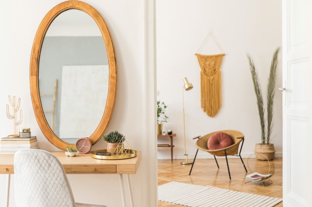 Stylish and minimalist interior of living room with design gold armchair.