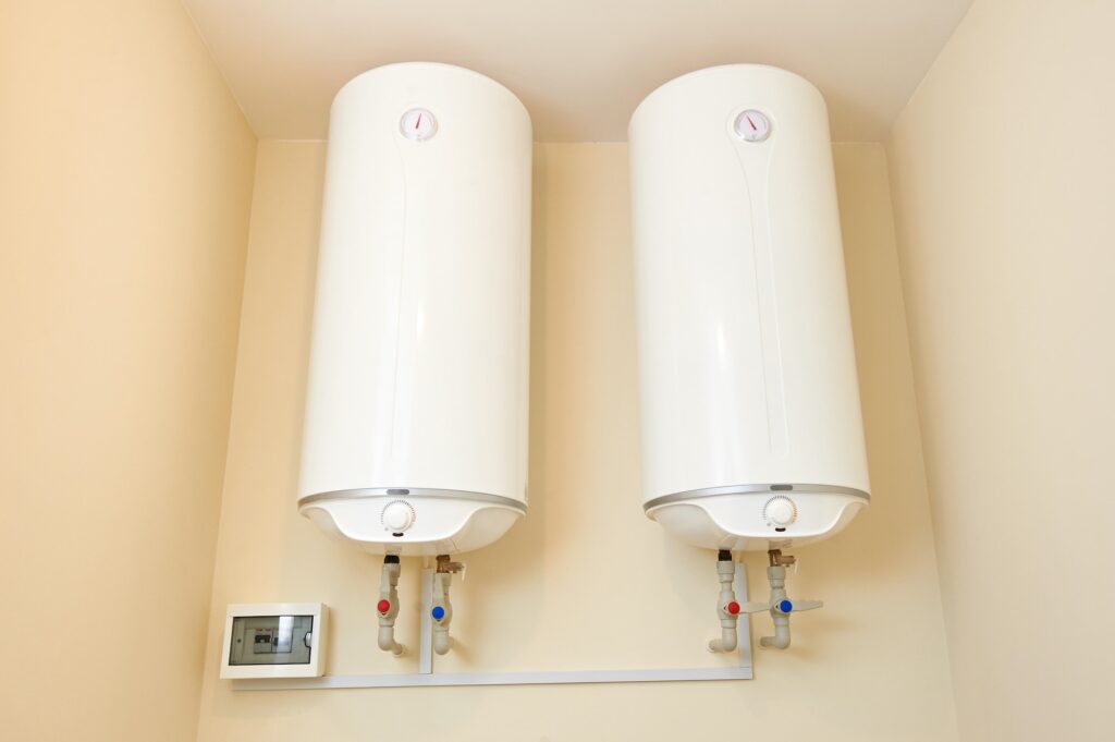 Two electric water heaters on the wall. Home wall mounted two water heating boilers.