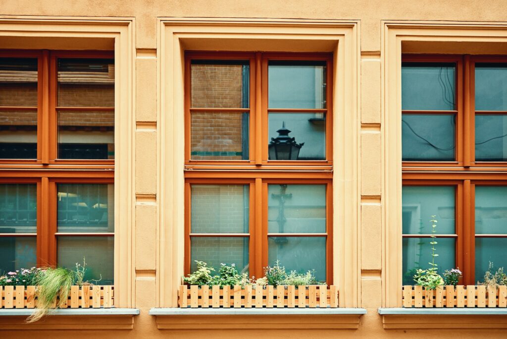 Vintage building facade with windows and flowers on windowsill