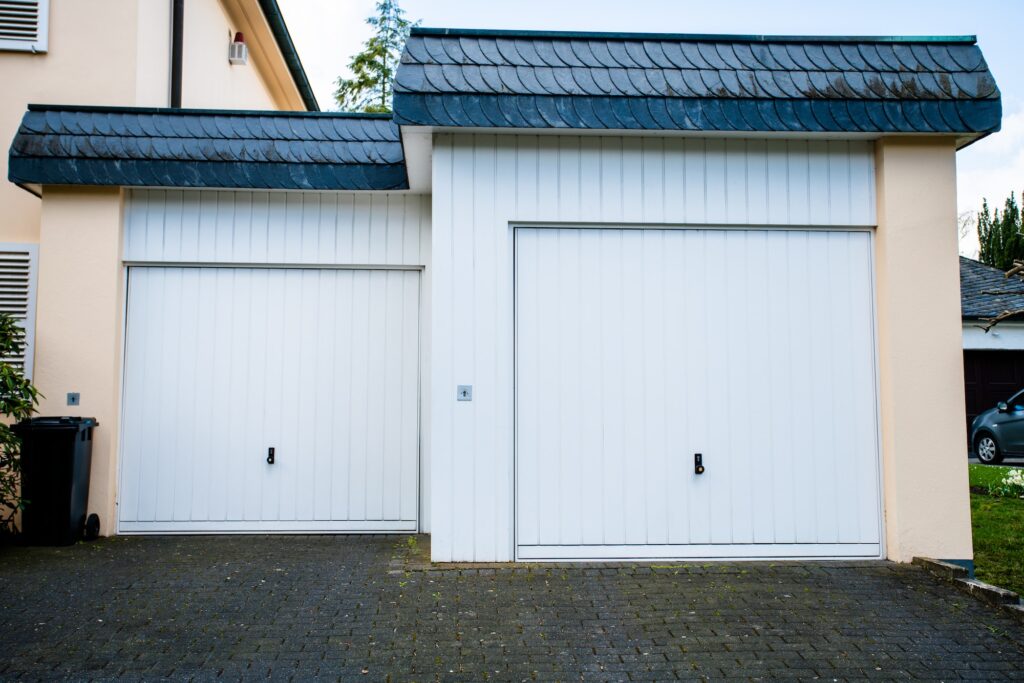 wide garage door and concrete driveway in front