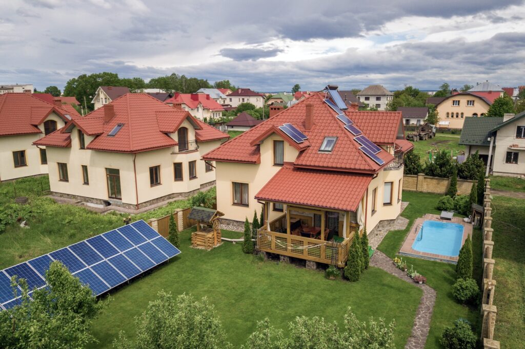 Aerial view of a new autonomous house with solar panels and water heating radiators on the roof and