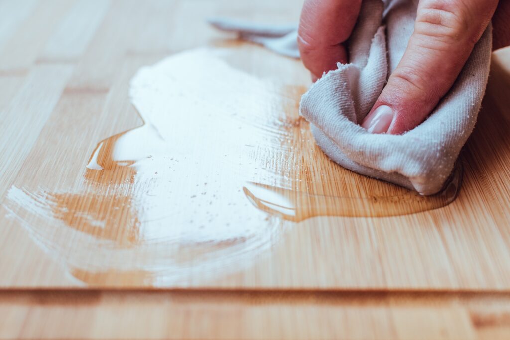 Applying wood care oil on a food cutting board.