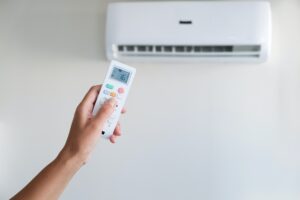 Cool air conditioner with remote control female hand, abnormal heat, heat rescue
