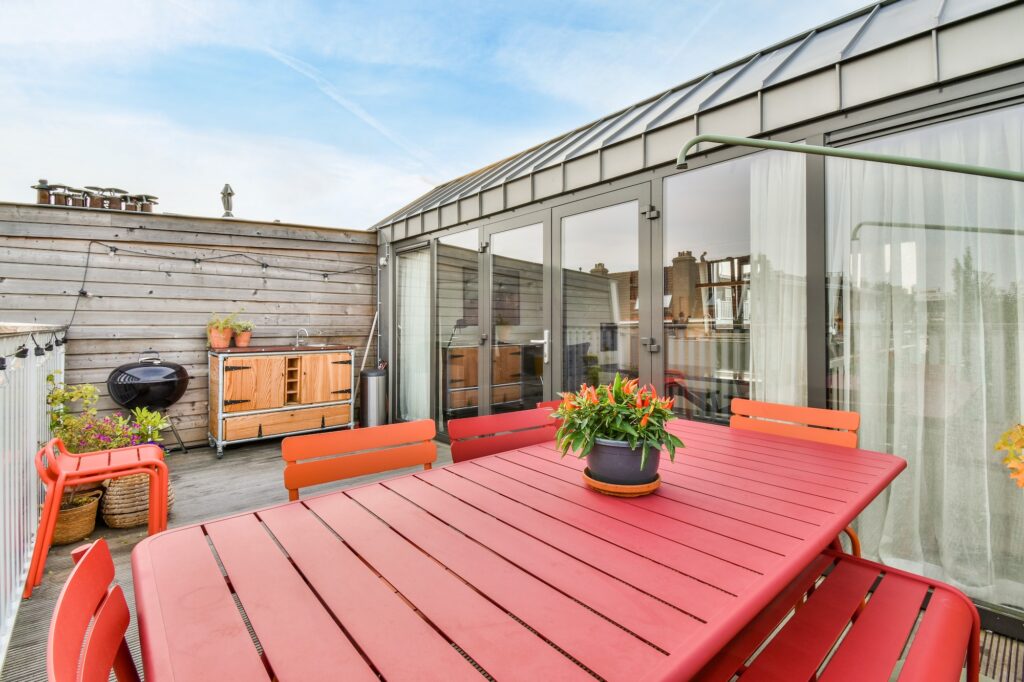 Delightful veranda with bright red wooden furniture