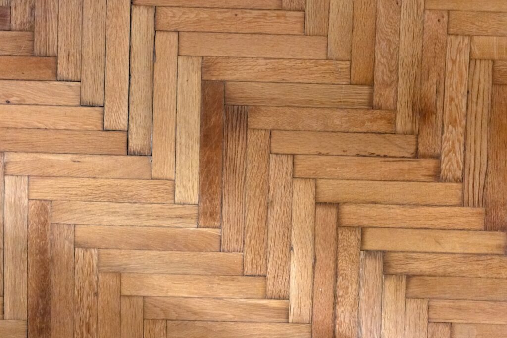 Herringbone pattern parquet wood floor texture. Wooden oak flooring background, overhead