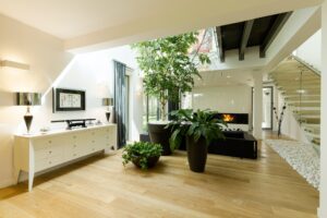 Spacious staircase with plants and skylight