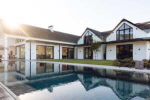 View of luxurious modern house exterior with garden and swimming pool