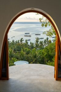 Window view at blue bay with boats stock photo