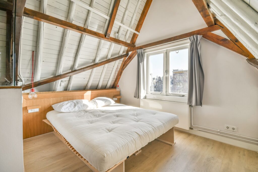 Attic bedroom interior with open restroom