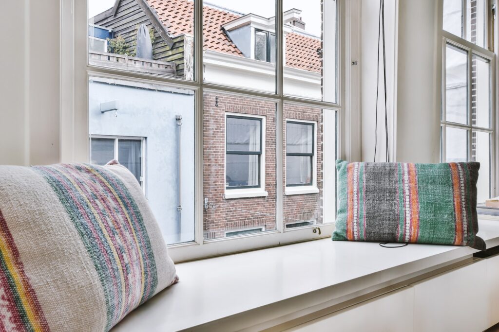Cushions on windowsill near window