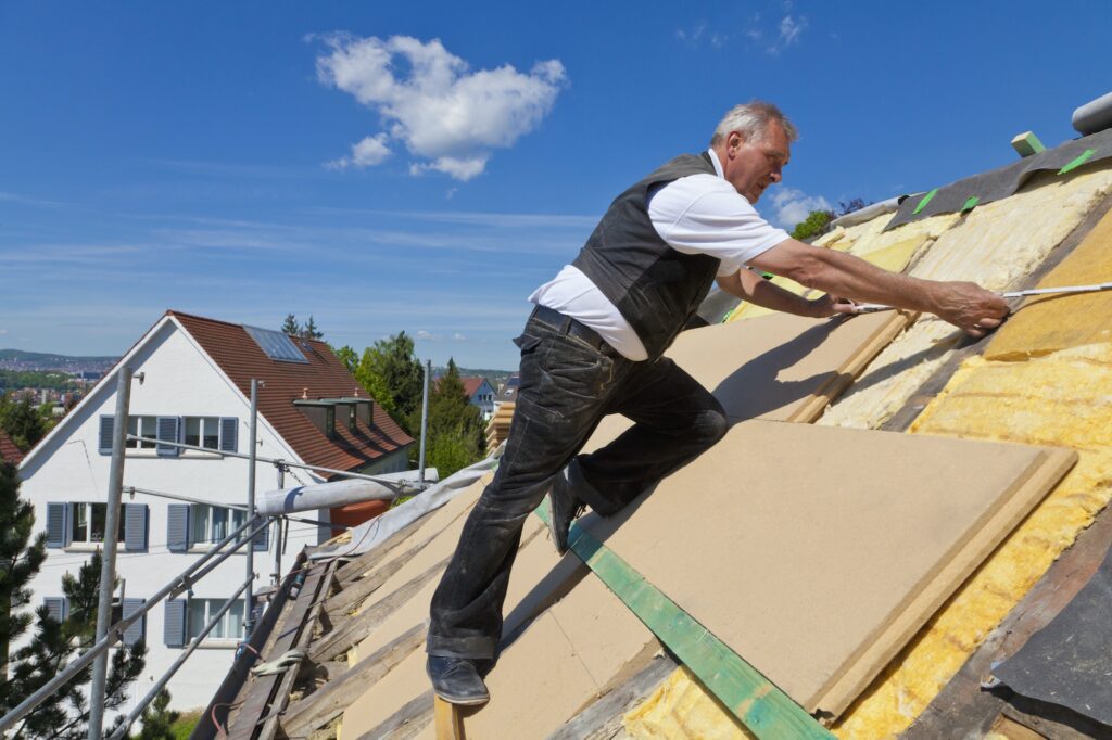Germany, Baden-Wuerttemberg, Stuttgart, Mature man placing insulation