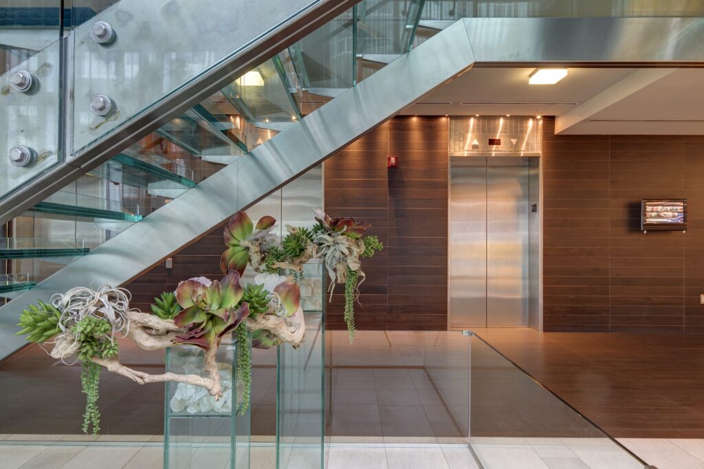 Glass staircase and elevators in hotel lobby