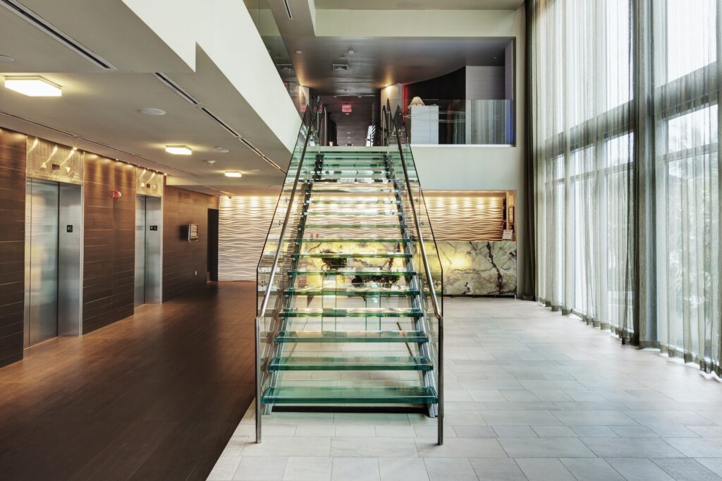 Glass staircase in hotel lobby