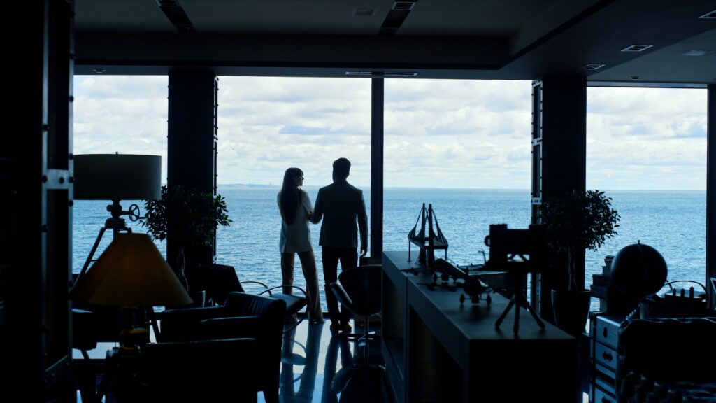 Silhouette colleagues meeting panoramic window workplace. Corporate lifestyle