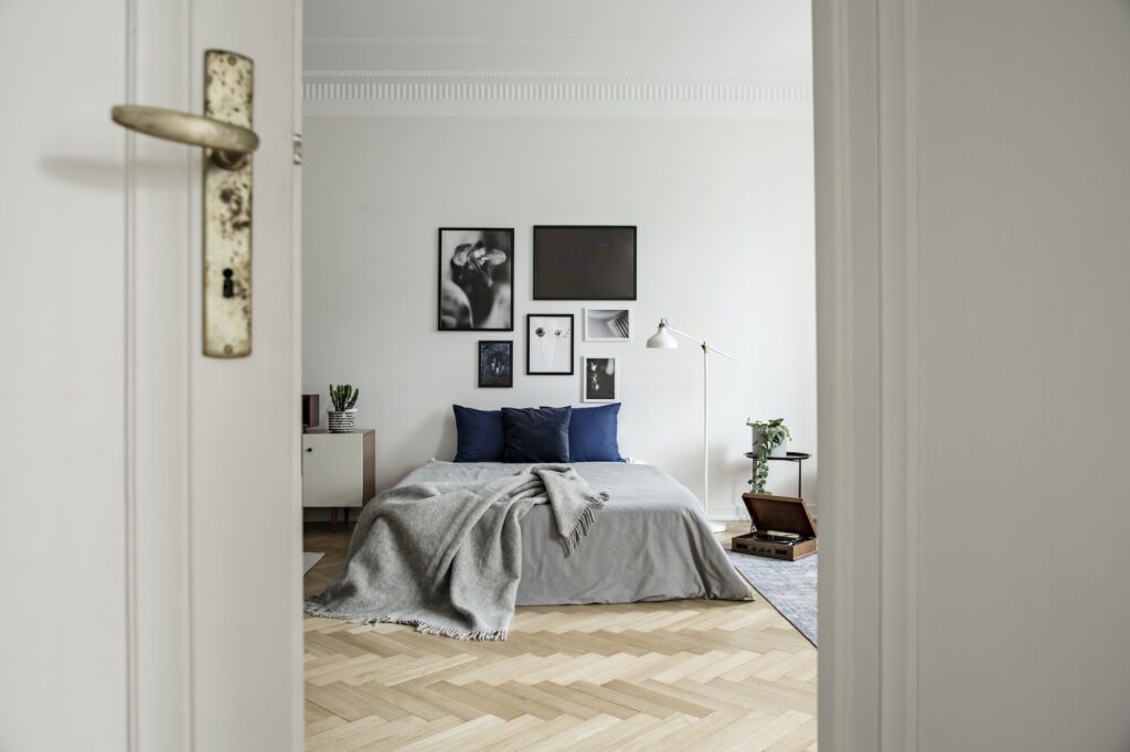 View through open door into a spacious and natural bedroom inter